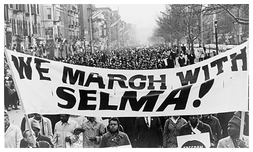 Marchers carrying banner lead way as 15,000 parade in Harlem