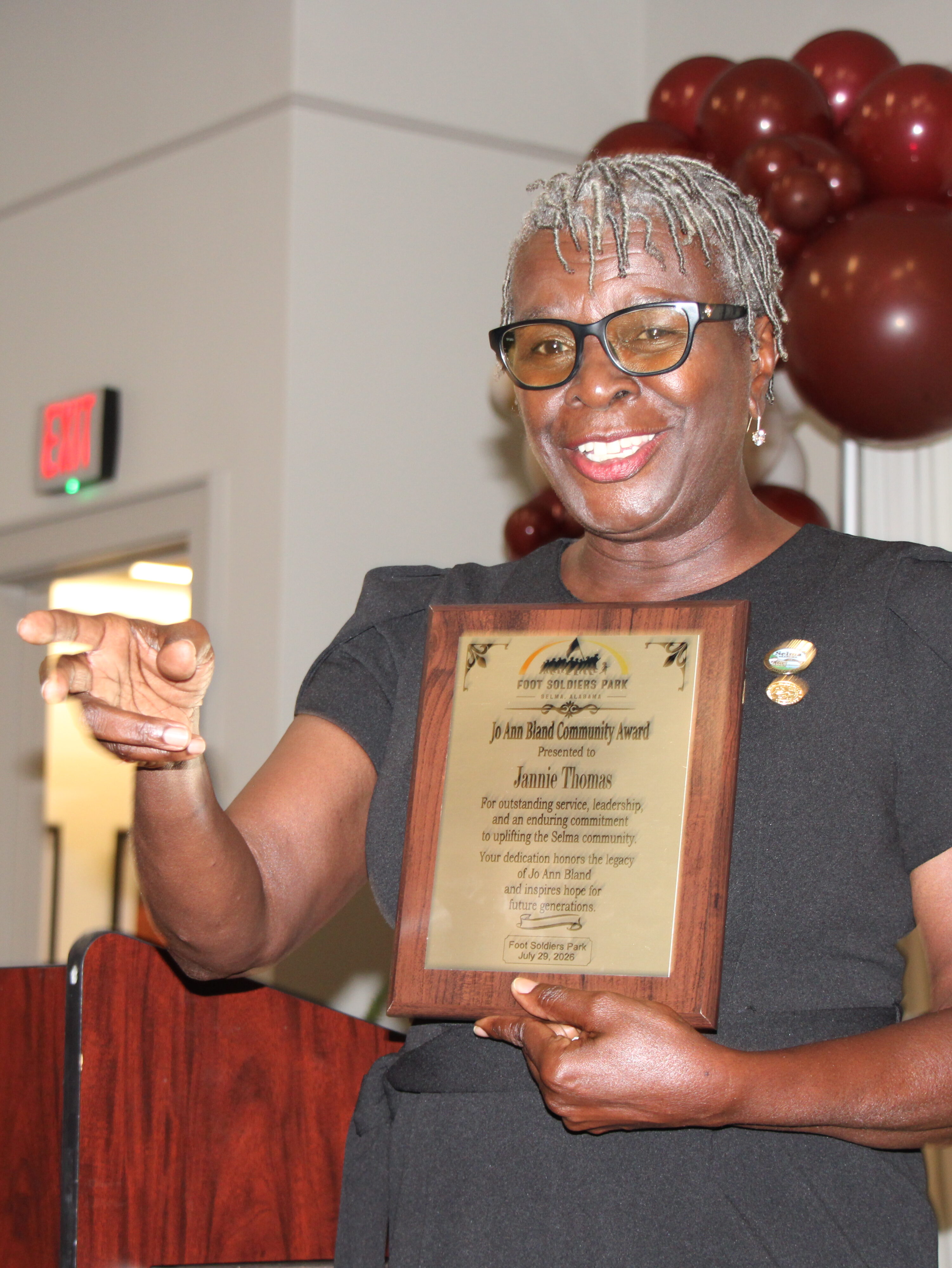 Jannie Thomas holding the Jo Ann Bland Day Award 